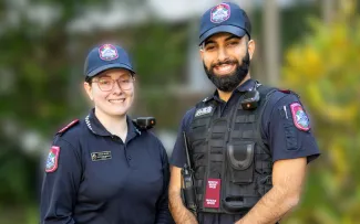 Two Protective Services Officers smiling