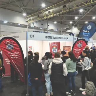 Protective Services Group Officers interacting with visitors at Career Expos